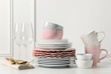 Wall Mural - Beautiful ceramic dishware, glasses, cups and cutlery on white marble table