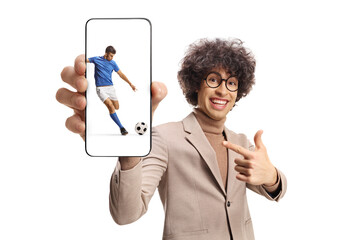 Poster - Happy young man pointing at a smartphone with football player on the screen