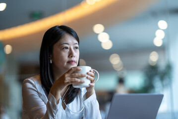 business person working on laptop in cafe