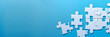 © Daniel - A white jigsaw puzzle on a blue background with blank space for an image. Creative banner. Copyspace image