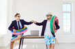 © Studio Romantic - Funny business male workers in sunglasses and beach hats standing at desk in office with rubber ring going on holiday trip and ready for summer vacation. Travel, journey and travelling concept.