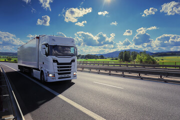 Wall Mural - Large Transportation Truck on a highway road through the countryside at sunset