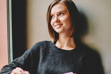 dreamy hipster girl with bestseller in hand thinking on continuation of literature plot resting in c