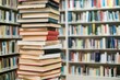 © abdulmoizjaangda - Tall stack of colorful books in calm, studious setting