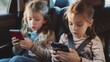 © Sarbinaz Mustafina - Two young girls are sitting in a car, each holding a cell phone. They are both looking at their phones, possibly texting or browsing the internet. Concept of boredom or restlessness