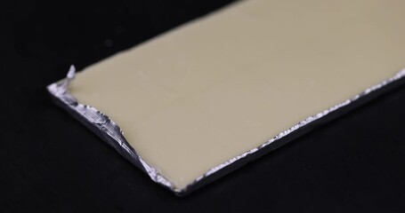 Wall Mural - new white chocolate bar packed in aluminum foil , delicious white chocolate bar with milk powder