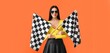 © Pixel-Shot - Pretty young woman holding racing flags on orange background