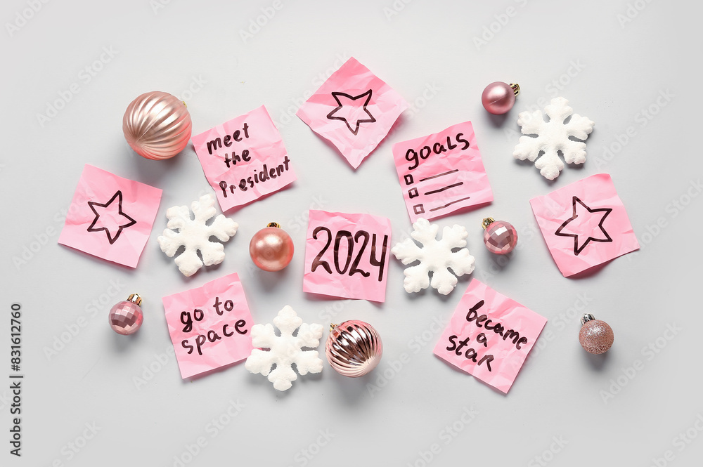 Sticky notes with different goals for 2024 and Christmas decorations on grey background