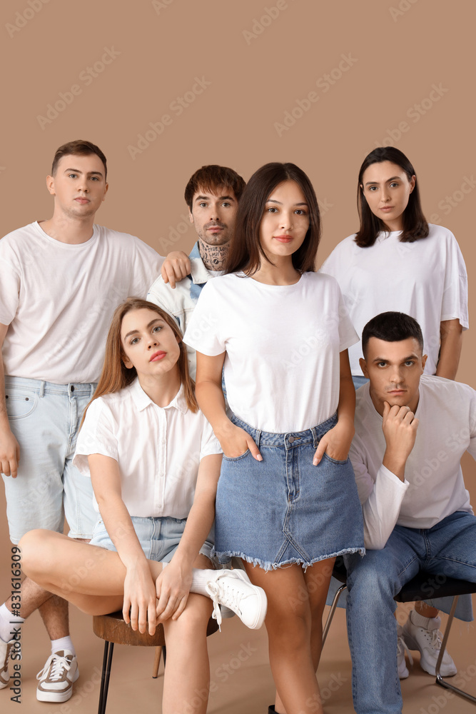 Group of stylish young people on brown background