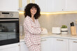 © New Africa - Beautiful young woman in stylish pyjama in kitchen