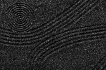 Texture of black sand with lines. Zen concept