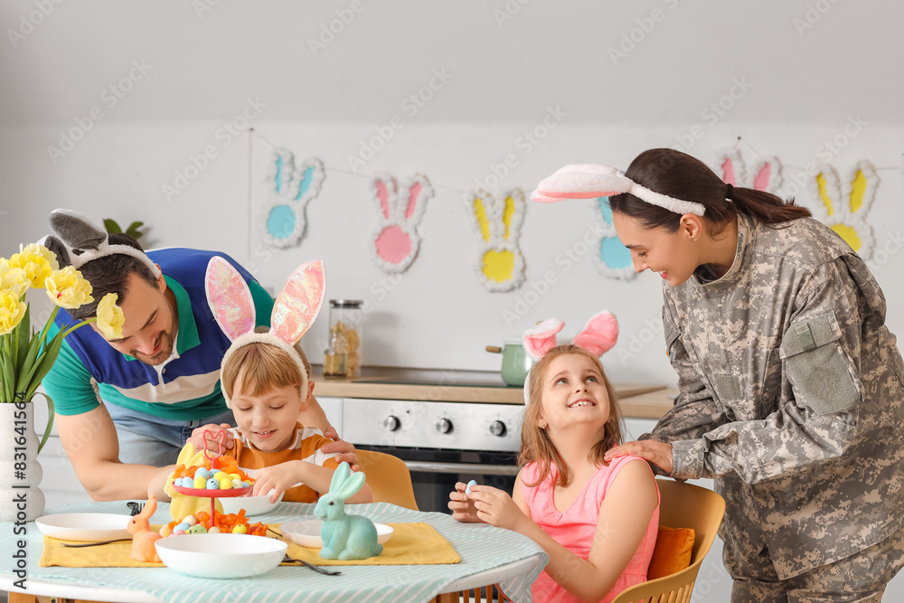 Female soldier with her family at Easter dinner in kitchen