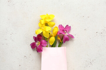 Wall Mural - Paper shopping bag with flowers on white grunge background