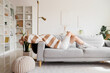 © Pixel-Shot - Young happy woman relaxing on cozy sofa in light living room