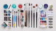© naphat - A flat lay composition featuring various art supplies spread out on a clean white desk. This could include paint brushes, tubes of paint, pencils, pens, markers, and a sketchbook.
