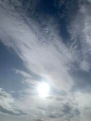 Wall Mural - blurred image of sky with clouds and sun.