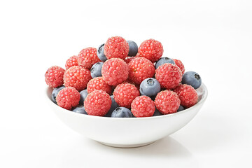 Canvas Print - Fresh Raspberries and Blueberries in a White Bowl