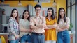 © inthasone - Group of Asia young creative people in smart casual wear smiling and arms crossed in a creative office workplace. Diverse Asian males and females stand together at startup. Coworker teamwork concept.