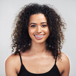 © Allistair/peopleimages.com - Studio, confidence and portrait of woman with hair care for shampoo growth, shine and satisfaction. Happy, person and relax with pride for salon, treatment and curly hairstyle on white background