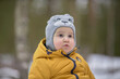 © justoomm - Little Sunshine: A Child in Yellow Jacket and Gray Hat