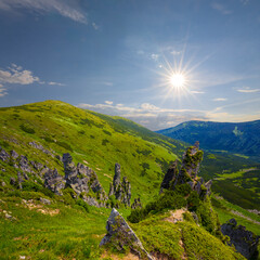 Wall Mural - wide green mountain valley under a sparkle sun