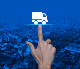 Sticker - Hand pressing delivery truck flat icon over modern city tower, street, expressway and skyscraper, Business transportation service concept