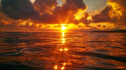 Wall Mural - the sun is setting over the ocean, casting a warm glow on the water