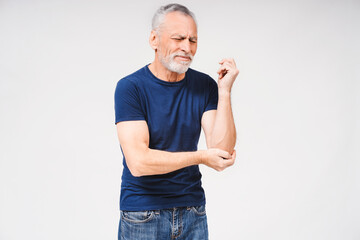 Middle age gray-haired bearded man suffering from pain in elbow on white background