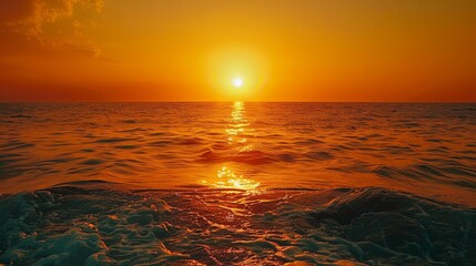 Wall Mural - the sun is setting over the ocean, casting a warm glow on the water