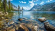 © Pik_Lover - A serene lake surrounded by mountains, with rocks and trees visible in the foreground and clear blue skies overhead.