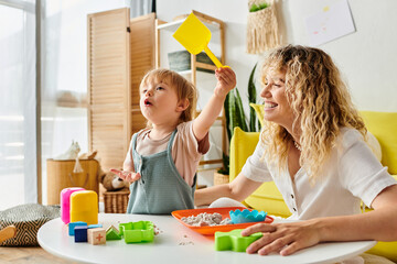 Wall Mural - A curly mother and her toddler daughter enjoying quality playtime using Montessori method of education at home.