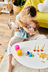 Wall Mural - a mother and her daughter, happily playing with dry pasta in a cozy living room filled with Montessori educational materials.