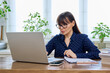 © Valerii Honcharuk - Middle-aged woman working with laptop, business papers, sitting at desk