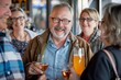 © Iigo - Group of senior friends toasting with glasses of beer in a pub