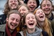 © Iigo - Group of young people having fun at a music festival, laughing.