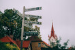 © robertharding - Signpost and St. John's Church in the Medieval Cesis Old Town, Cesis, Latvia, Baltics