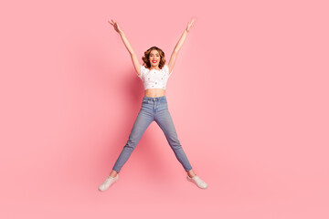 Poster - Full size photo of lovely young woman jump raise hands stretch legs dressed stylish white garment hairdo isolated on pink color background