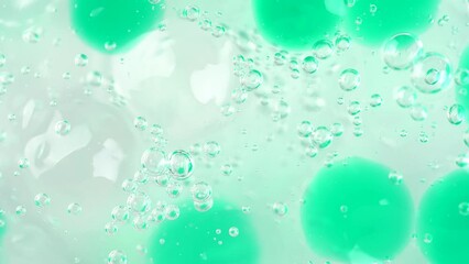 Wall Mural - Transparent white gel fluid with green bubbles, rotating. Macro texture of colorful cleansing gel. Aloe vera cosmetics gel