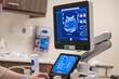 © Image Source - An ultrasound machine with a live scan displayed on the monitor in a clinical setting, controlled by a healthcare professional partially seen.