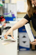© Connect Images - Woman packaging items in an office setting