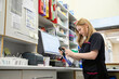 © Connect Images - Veterinary technician scanning item at clinic workstation