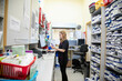 © Connect Images - Pharmacist working at a computer in a pharmacy surrounded by medication shelves.