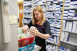 © Connect Images - Pharmacist organizing medications in a storage room