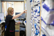 © Connect Images - Nurse retrieving a file from a hospital storage system