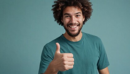 Poster - Joyful curly-haired man in teal shirt giving a thumbs up. Vibrant studio shot with a playful tone.