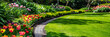 © queen - peaceful green garden with winding pathway and blooming flowers
