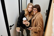 © Bliss - Two women, a young lesbian couple, stand side by side, with luggage at their feet