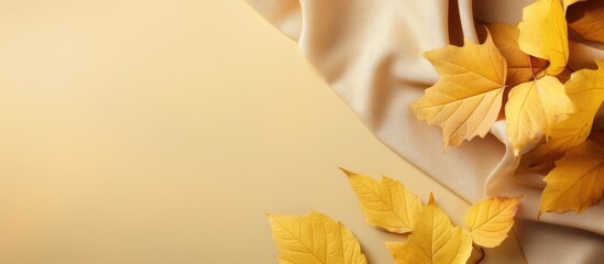 Poster - Autumn background Yellow leaves on a beige suede free space for text. copy space available