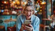 © Oulaphone - Cheerful excited young woman with good news reading mail on smartphone sitting in coffee shop, Emotional woman happy about getting discount for internet communication checking news on telephone.