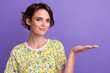 © deagreez - Photo of pretty young woman arm hold empty space wear t-shirt isolated on violet color background